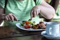 Woman in green dress eating lunch in outdoor cafe, selective focus - image Royalty Free Stock Photo