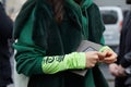 Woman with green fur jacket and hoodie before Diesel Black Gold fashion show, Milan Fashion Week street style