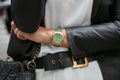 Woman with green and gold Rolex Daydate watch before Emporio Armani fashion show, Milan Fashion