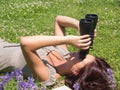 Woman on green grass and binoculars