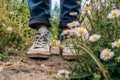 woman green grass spring lifestyle fashion white sneakers female outdoors flowers. Generative AI. Royalty Free Stock Photo