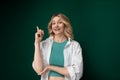 Woman in Green Shirt Holding a Cigarette Royalty Free Stock Photo