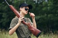 Woman green sunglasses weapon hunting lifestyle overalls Royalty Free Stock Photo