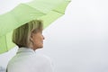 Woman With Green Umbrella Against Clear Sky