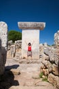 Woman greeting in prehistoric Taula in Minorca Island Royalty Free Stock Photo