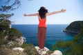 Woman greeting at top of cliff Royalty Free Stock Photo