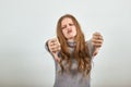 Woman in grey sweater an enraged girl returns thumbs down demonstrates anger