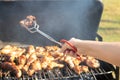 Woman is grilling steaks, grill sausages and chicken wings and u Royalty Free Stock Photo