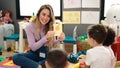 Woman and group of kids having vocabulary lesson with word cards at kindergarten Royalty Free Stock Photo