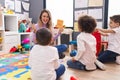 Woman and group of kids having vocabulary lesson with word cards at kindergarten Royalty Free Stock Photo