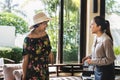 Women guest talking to receptionist at a hotel lobby