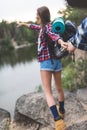 woman guiding boyfriend to wild lake Royalty Free Stock Photo