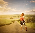 Woman with guitar at freeway