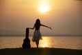 Woman with guitar hard case at the sea