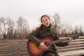 Woman with a guitar showing her tongue Royalty Free Stock Photo