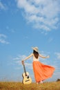 Woman and guitar standing and Cloud sky