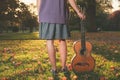 Woman with guitar at sunset in the park Royalty Free Stock Photo