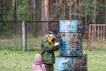 Woman with gun and baby daugter playing lazer tag.