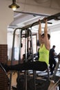 Woman at the gym doing exercises the legs to the top Royalty Free Stock Photo