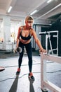 Woman in the gym doing single arm dumbbell row