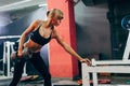 Woman in the gym doing single arm dumbbell row