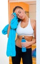 Woman in gym with isotonic bottle