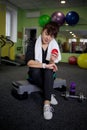 woman in the gym looking at her watch Royalty Free Stock Photo