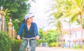 Woman with gym suit ride bike for exercise in village garden in