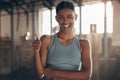 Woman in gym, thumbs up with wink in portrait, like fitness with emoji and health goals with sport and mockup space