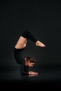 Woman in gymnastic pose on black background stretching doing Han