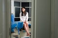 Woman at gynecologist office sitting and waiting for a doctor with test results, view through a door Royalty Free Stock Photo