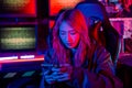 Woman hacker. Asian woman wearing hood working at computer and mobile phone Royalty Free Stock Photo