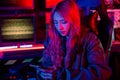 Woman hacker. Asian woman wearing hood working at computer and mobile phone Royalty Free Stock Photo