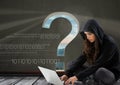 Woman hacker seated and working on a laptop with a grey background with a question mark