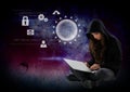 Woman hacker using a laptop in front of digital background Royalty Free Stock Photo