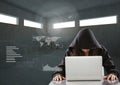 Woman hacker working on laptop in a dark room