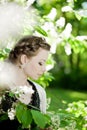 Woman with a hair braid in a blossoming park.