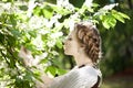 Woman with a hair braid in a blossoming park.