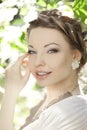 Woman with a hair braid in a blossoming park.