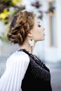 Woman with a hair braid in a blossoming park.