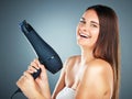 Woman, hair dryer and salon with smile for beauty, skincare or cosmetics against a studio background. Portrait of happy Royalty Free Stock Photo