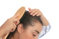 Woman with hair loss problem on white background, closeup. Trichology treatment