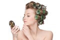 Woman in hair roller looking in mirror Royalty Free Stock Photo
