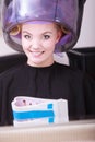 Woman hair rollers curlers reading magazine hairdryer beauty salon Royalty Free Stock Photo