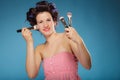 Woman in hair rollers holds makeup brushes Royalty Free Stock Photo