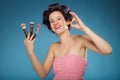 Woman in hair rollers holds makeup brushes Royalty Free Stock Photo