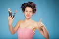 Woman in hair rollers holds makeup brushes Royalty Free Stock Photo