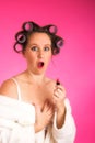 Woman in hair rollers and robe Royalty Free Stock Photo