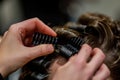 A woman is at a hair salon, having her hair done by a professional stylist, A close-up image of a hairdresser Royalty Free Stock Photo
