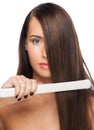 Woman with hair straightening irons Royalty Free Stock Photo